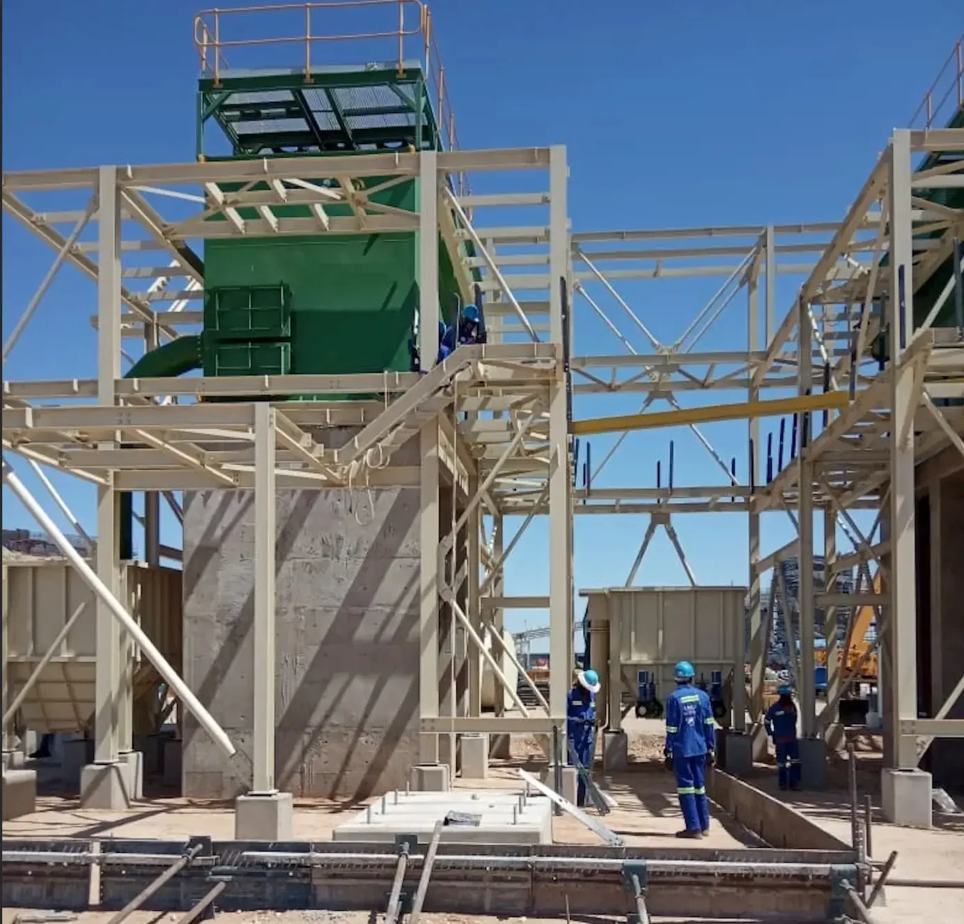 Structural design in action – engineers and workers on site installing and inspecting a steel framework for a commercial building project.